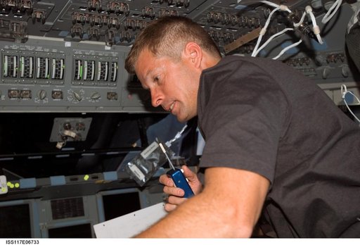 Swanson uses communication equipment in the FD of STS-117 Space Shuttle Atlantis