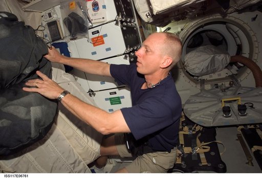 Reilly works with CTB in the FWD MDDK of STS-117 Space Shuttle Atlantis