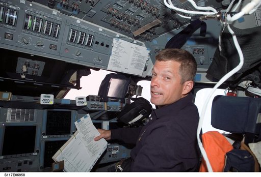Swanson looks at crew procedures in the FD on STS-117 Space Shuttle Atlantis