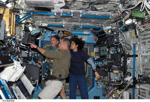 STS-117 and Expedition 15 crewmembers in the U.S. Laboratory during Joint Operations