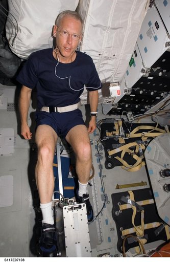 Forrester exercises on a bicycle ergometer on the MDDK of Space Shuttle Atlantis during Joint Operations