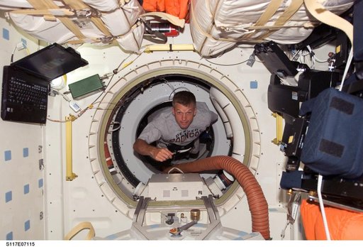 Swanson floats through hatch to the MDDK of STS-117 Space Shuttle Atlantis during Joint Operations