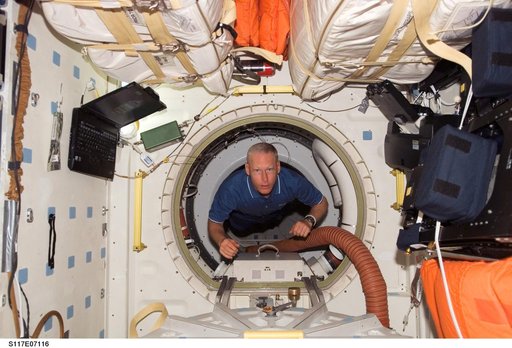 Forrester floats through hatch to the MDDK of STS-117 Space Shuttle Atlantis during Joint Operations