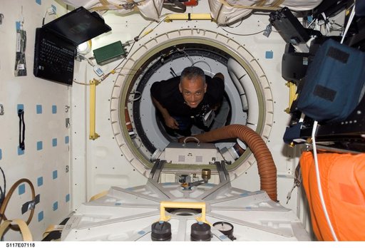 Olivas floats through hatch to the MDDK of STS-117 Space Shuttle Atlantis during Joint Operations
