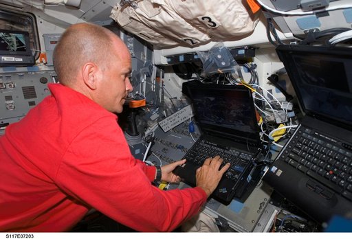 Astronaut Rick Sturckow, STS-117 commander, uses a computer on the FD during Joint Operations