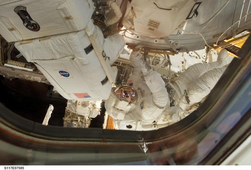 Reilly and Olivas install a water to hydrogen vent on the outside of the U.S. Laboratory during EVA 3