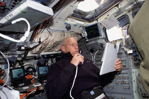 Forrester uses communication equipment in the aft FD window on STS-117 Space Shuttle Atlantis