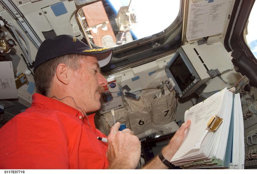 Reilly uses communication equipment in the aft FD on Space Shuttle Atlantis during Joint Operations