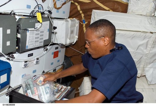 View of Drew stowing a FDF Accessory Kit in the MDDK during STS-118