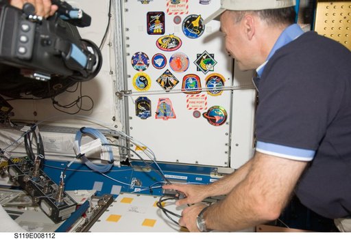 Archambault places STS-119 patch in Node 1 Unity