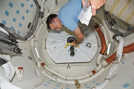 Archambault and Phillips work to close shuttle airlock hatch