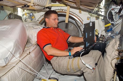 Wheelock with computer on Discovery middeck