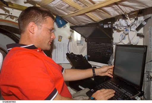 Wheelock with computer on Discovery middeck