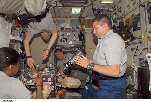 STS-120 and Expedition 16 crew share meal in Zvezda module