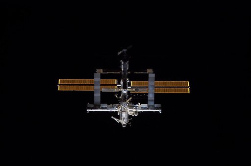 Nadir view of the ISS as the orbiter Discovery moves in for docking during STS-121