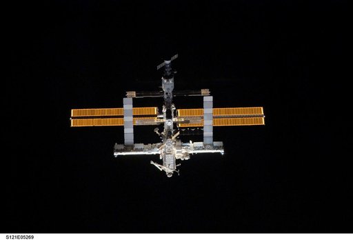 Nadir view of the ISS as the orbiter Discovery moves in for docking during STS-121