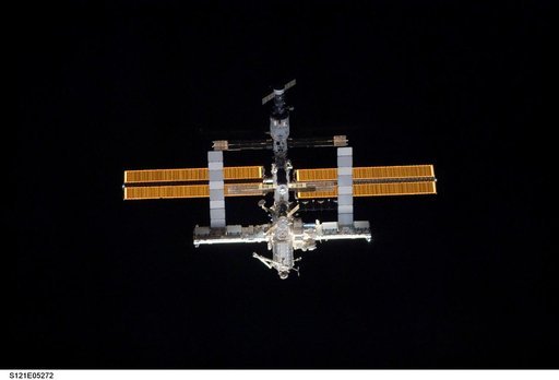 Nadir view of the ISS as the orbiter Discovery moves in for docking during STS-121