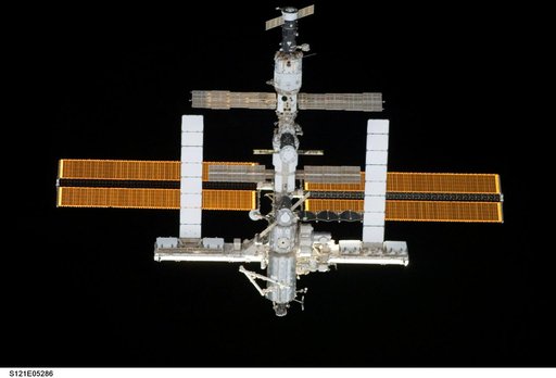 Nadir view of the ISS as the orbiter Discovery moves in for docking during STS-121