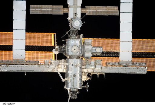 Nadir view of the ISS as the orbiter Discovery moves in for docking during STS-121