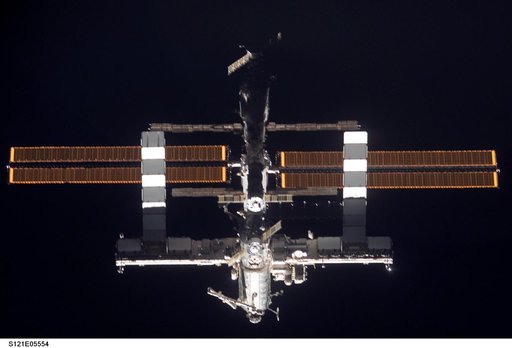 Nadir view of the ISS as the orbiter Discovery moves in for docking during STS-121