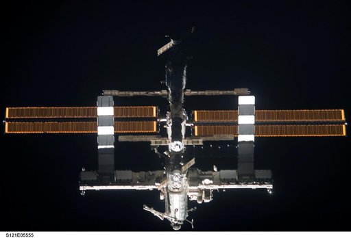 Nadir view of the ISS as the orbiter Discovery moves in for docking during STS-121
