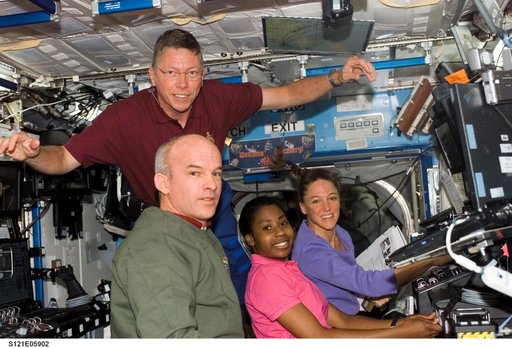 Exp. 13 and STS-121 crewmembers work in the U.S. Lab during STS-121/Exp. 13 OPS