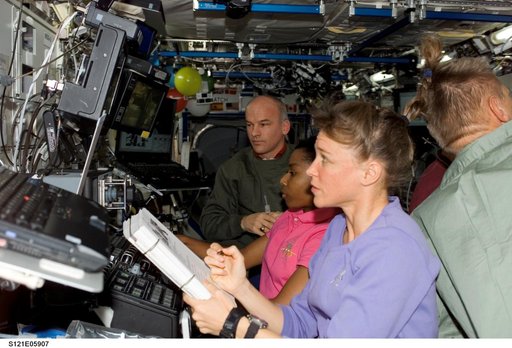 Nowak and Wilson work at the SSRMS during STS-121/Exp. 13 OPS