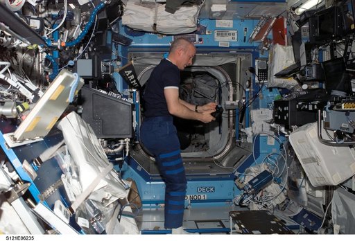 Williams with camera flash in the U.S. Lab during STS-121 / Expedition 13 joint operations