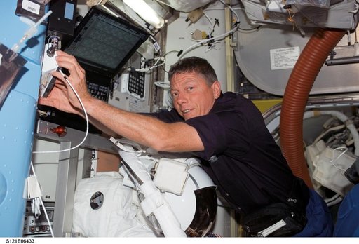 Fossum stows tools in the A/L during STS-121 / Expedition 13 joint operations