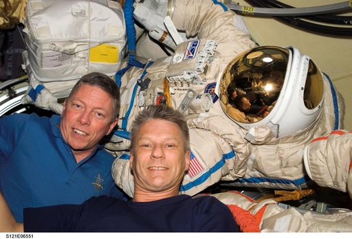 Fossum and Sellers with Orlan Suit inside the DC during STS-121 / Expedition 13 joint operations