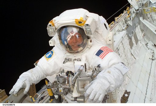 Fossum smiles at the camera during EVA3 on STS-121 / Expedition 13 joint operations