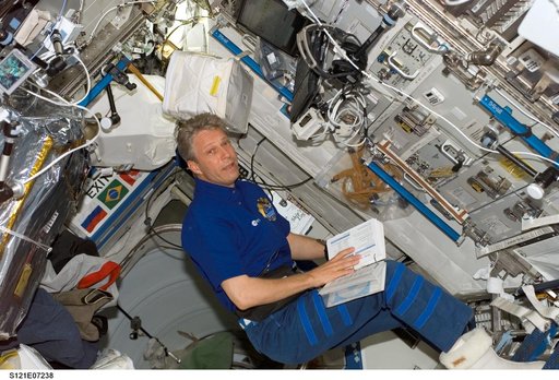 Reiter reads procedures while working in the U.S. Lab during STS-121 / Expedition 13 joint operations