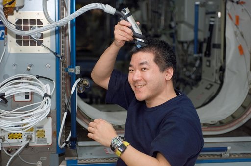 Tani trims his hair in Node 2