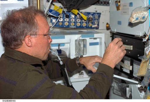 Gorie enjoys drink in the MDDK during STS-123 mission