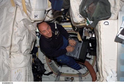 Reisman uses computer in the MDDK during STS-123 mission