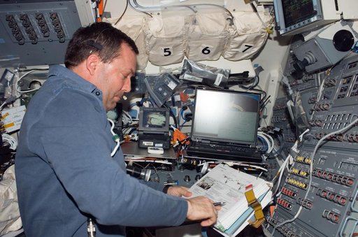 Foreman looks over crew procedures during Expedition 16 / STS-123 Joint Operations