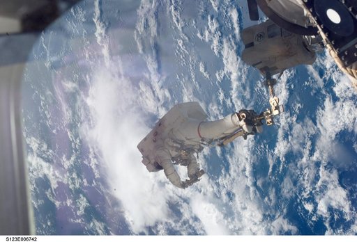 Linnehan anchored to a Canadarrm2 mobile foot restraint during Expedition 16 / STS-123 Joint Operations