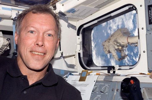 Linnehan anchored to a Canadarrm2 mobile foot restraint during Expedition 16 / STS-123 Joint Operations