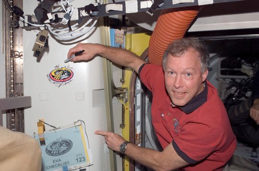 Gorie signs STS-123 patch in the A/L during Joint Operations