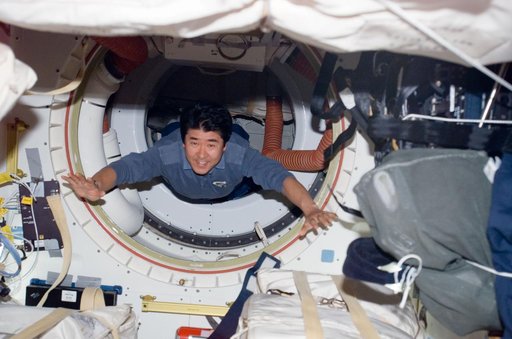 Doi passes through A/L hatch on Space Shuttle Endeavor during Joint Operations