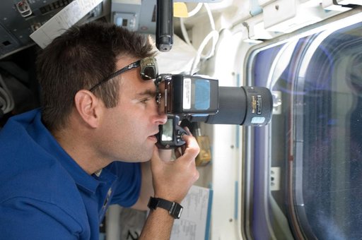 Chamitoff on aft flight deck with camera