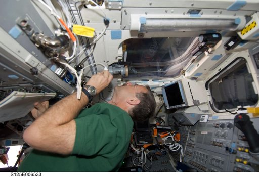 Altman working on the Shuttle Atlantis Flight Deck