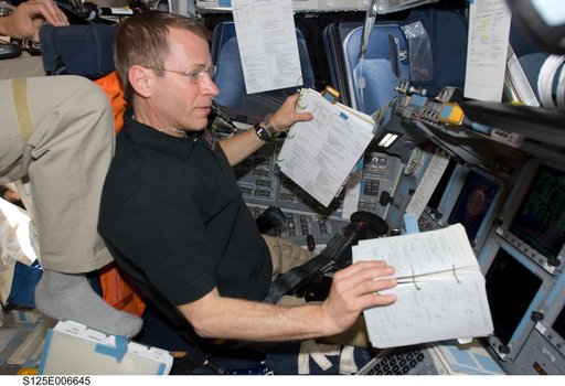 STS-125 Crew working on the Shuttle Atlantis Flight Deck during HST Rendezvous