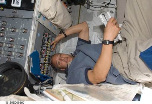 STS-125 Crew working on the Shuttle Atlantis Flight Deck during HST Rendezvous