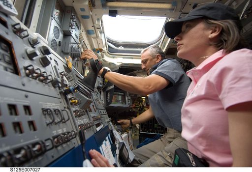 STS-125 Crew working on the Shuttle Atlantis Flight Deck during HST Rendezvous/Berthing