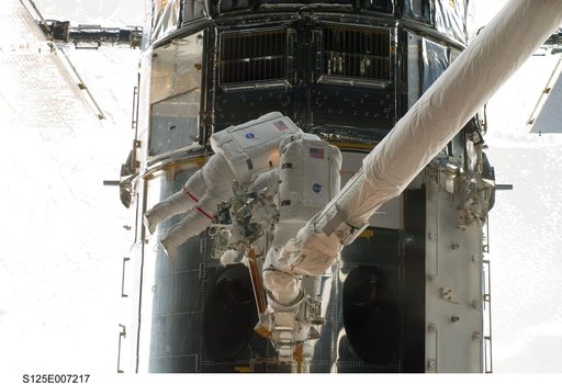 STS-125 MS5 Feustel and MS3 Grunsfeld during EVA1