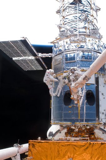 STS-125 MS5 Feustel and MS3 Grunsfeld during EVA1