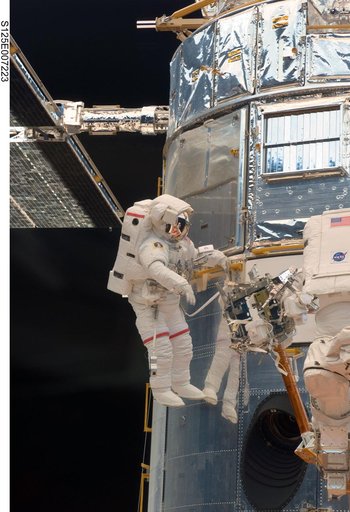 STS-125 MS5 Feustel and MS3 Grunsfeld during EVA1