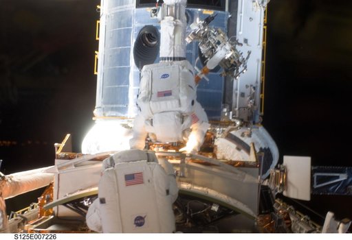 STS-125 MS5 Feustel and MS3 Grunsfeld during EVA1