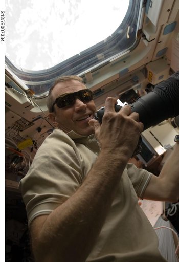 STS-125 Pilot Johnson takes photos during Flight Day 4